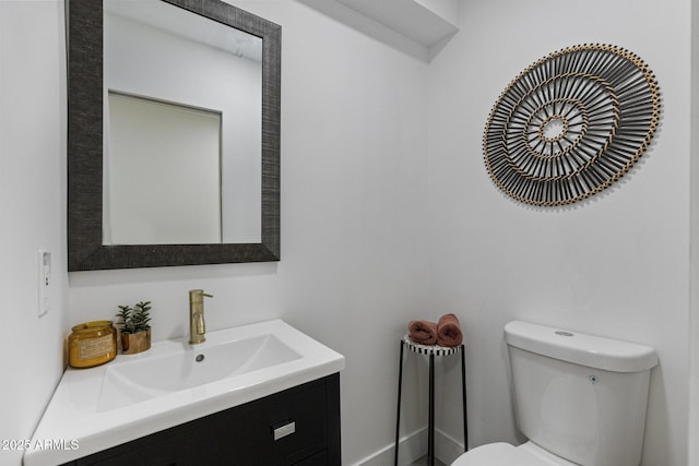 half bathroom with toilet and vanity