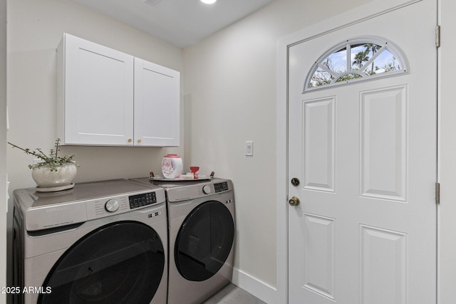 laundry area featuring baseboards, cabinet space, and independent washer and dryer
