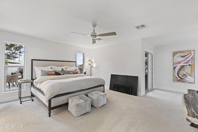 bedroom with carpet flooring, multiple windows, baseboards, and visible vents