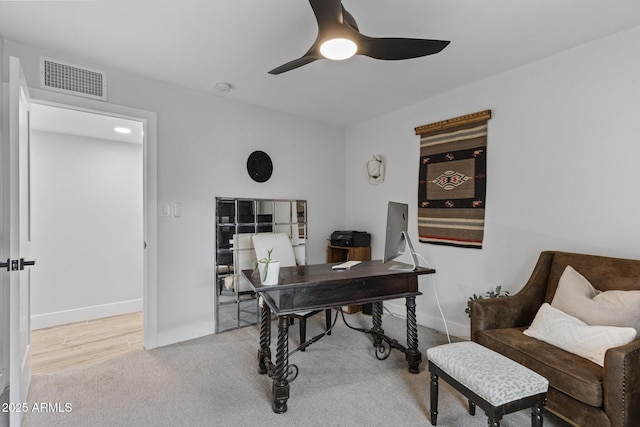 carpeted home office with visible vents, baseboards, and ceiling fan
