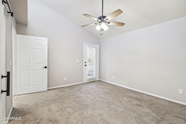 empty room featuring light colored carpet, ceiling fan, and lofted ceiling