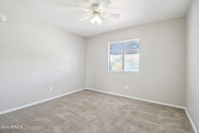 spare room with carpet and ceiling fan