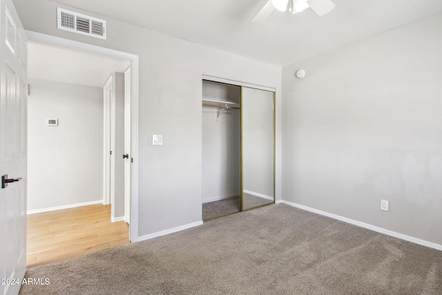 unfurnished bedroom featuring carpet floors, a closet, and ceiling fan