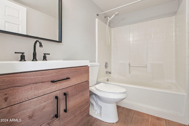 full bathroom featuring wood-type flooring, vanity, toilet, and shower / washtub combination