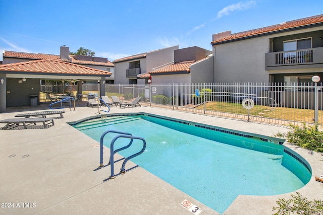 view of swimming pool featuring a patio area