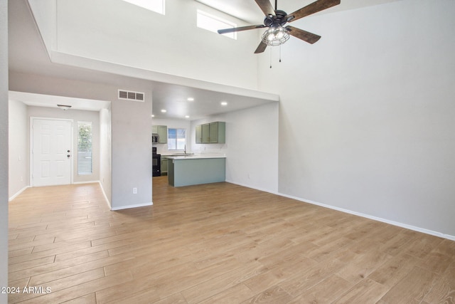 unfurnished living room with ceiling fan and light hardwood / wood-style floors