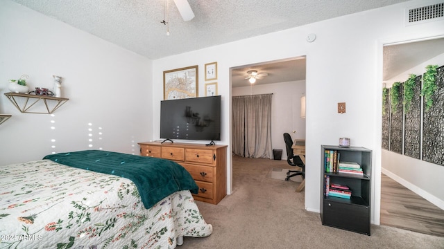 carpeted bedroom with a textured ceiling and ceiling fan