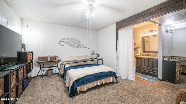 bedroom featuring ensuite bath, ceiling fan, carpet floors, and a textured ceiling