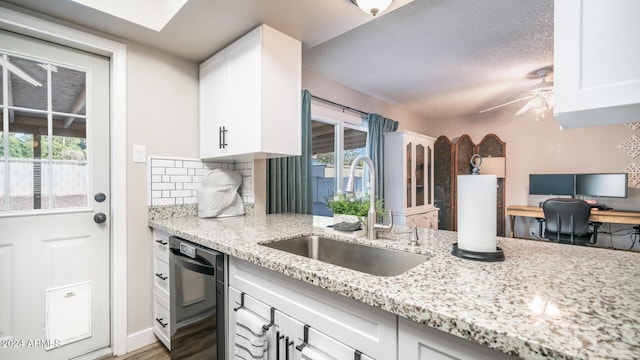 kitchen featuring white cabinetry, dishwasher, and sink