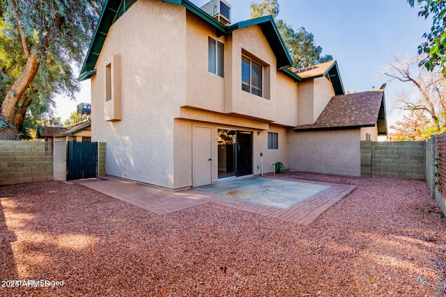 back of property with a patio