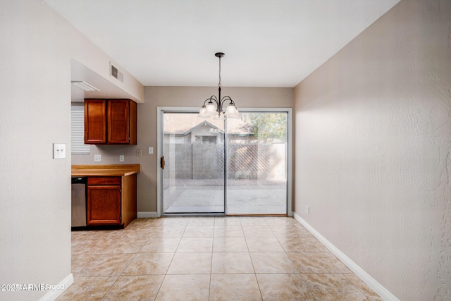 unfurnished dining area featuring an inviting chandelier and light tile patterned floors