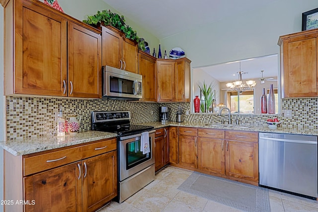 kitchen featuring appliances with stainless steel finishes, brown cabinets, and a sink