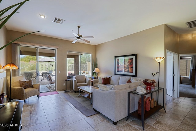 living area featuring ceiling fan, visible vents, and a healthy amount of sunlight