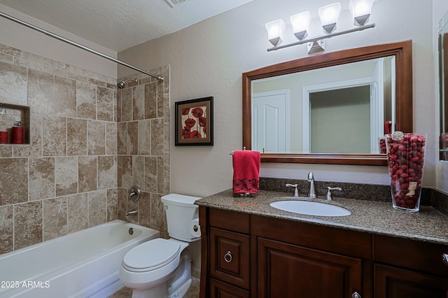 bathroom featuring toilet, bathing tub / shower combination, vanity, and a textured ceiling