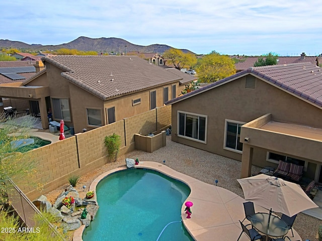 view of swimming pool with a fenced backyard, a mountain view, a fenced in pool, and a patio