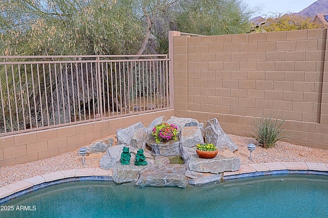 view of pool featuring fence