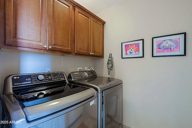 laundry area featuring cabinet space and washing machine and clothes dryer