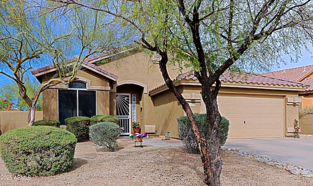 view of front facade featuring concrete driveway, a tile roof, an attached garage, and stucco siding