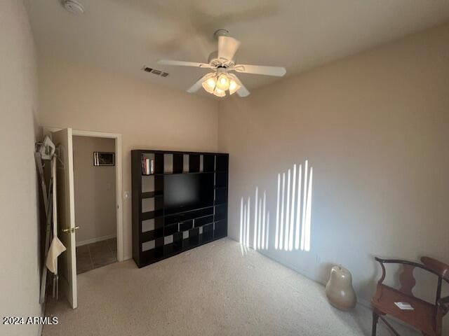 living room with ceiling fan and carpet