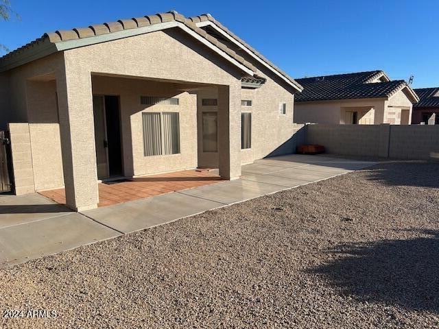 back of property with a patio