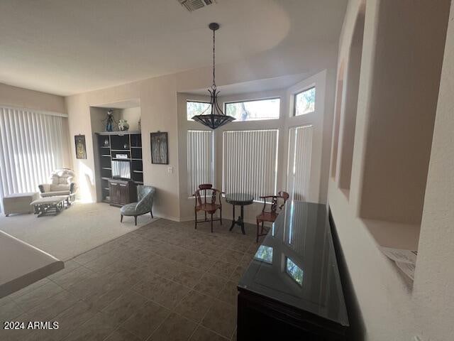 living room with dark carpet and a wealth of natural light