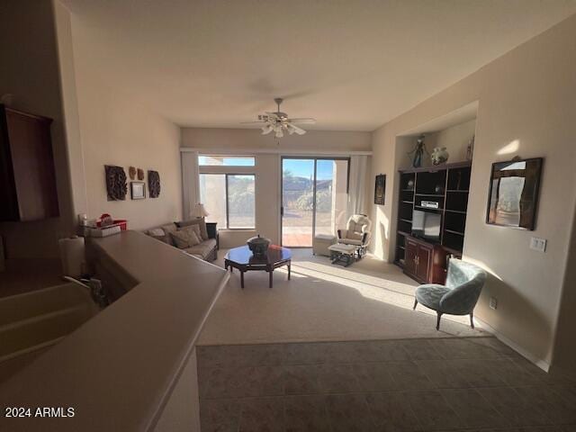 living room featuring sink and ceiling fan