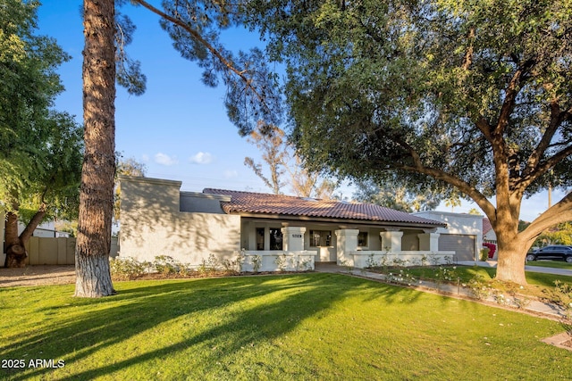 mediterranean / spanish house featuring a front lawn