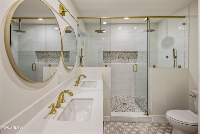 bathroom featuring tile patterned floors, toilet, a shower with door, and vanity