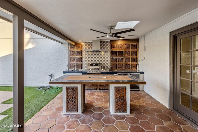 view of patio with ceiling fan and an outdoor kitchen