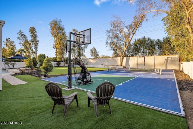 view of basketball court featuring tennis court and a yard