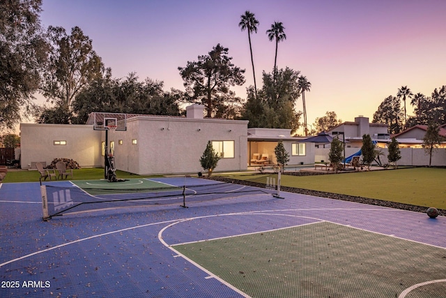 view of basketball court with a lawn