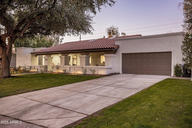 view of front of house with a garage and a yard