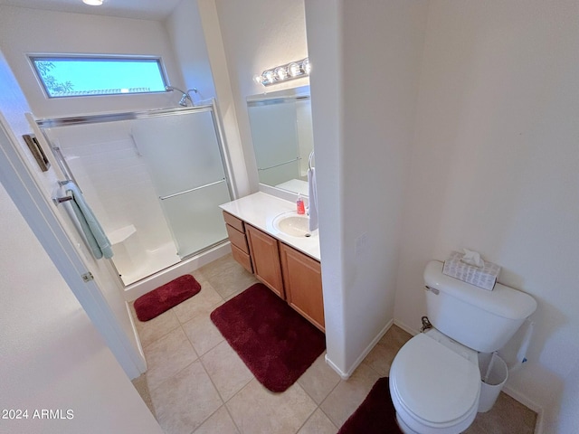 bathroom featuring vanity, a shower with shower door, toilet, and tile patterned flooring