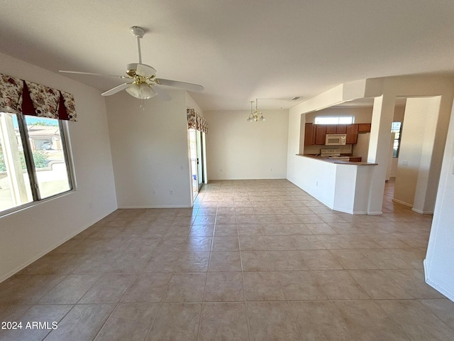 unfurnished living room featuring light tile patterned flooring and ceiling fan with notable chandelier