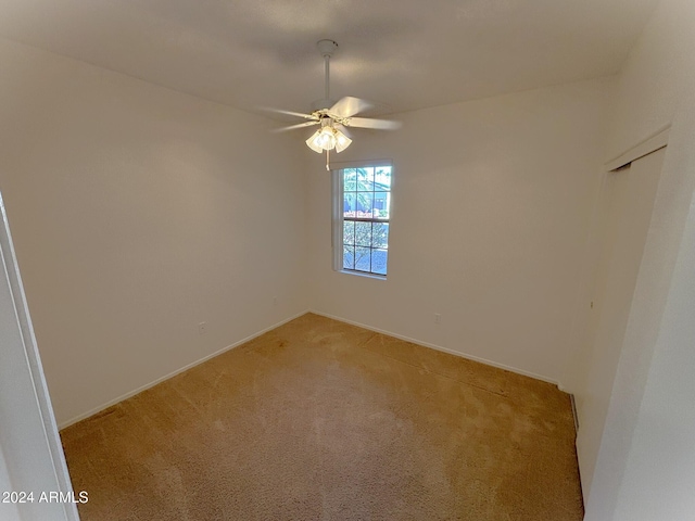 empty room featuring carpet and ceiling fan