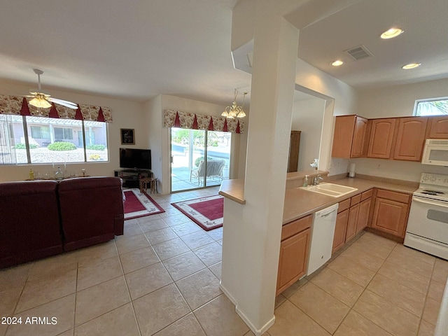 kitchen with white appliances, light tile patterned flooring, sink, kitchen peninsula, and pendant lighting