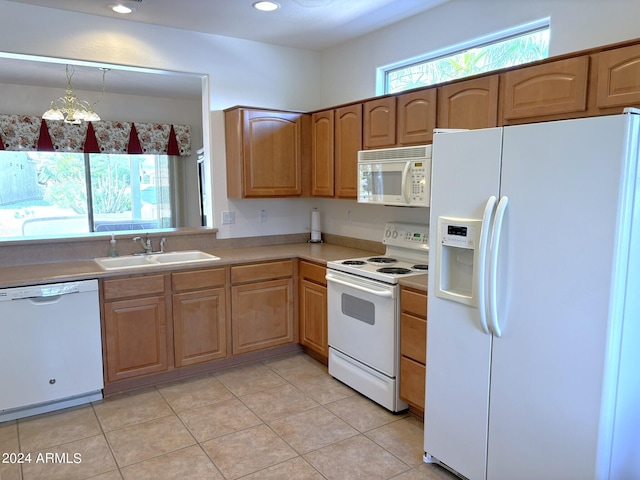 kitchen featuring white appliances, a notable chandelier, light tile patterned flooring, and sink