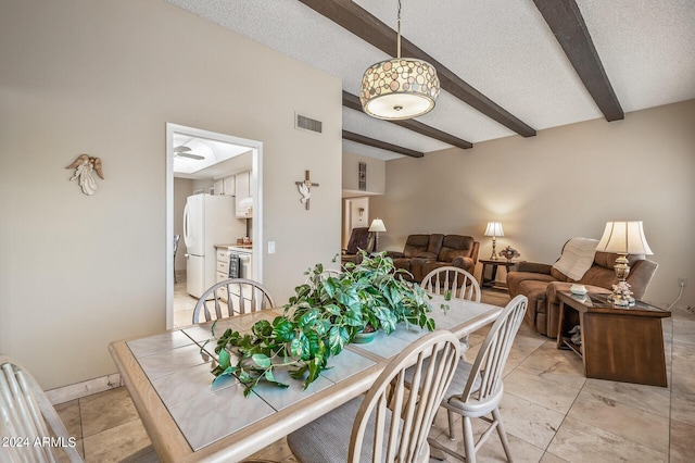 dining area with beam ceiling, visible vents, and a textured ceiling