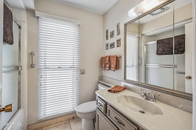 full bath featuring visible vents, toilet, enclosed tub / shower combo, vanity, and tile patterned floors