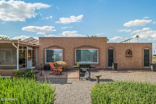 back of house with a patio area and stucco siding