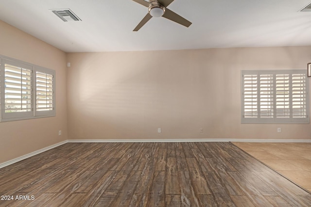 empty room featuring hardwood / wood-style flooring, plenty of natural light, and ceiling fan