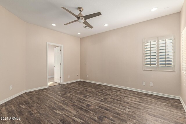 empty room featuring ceiling fan and dark wood-type flooring