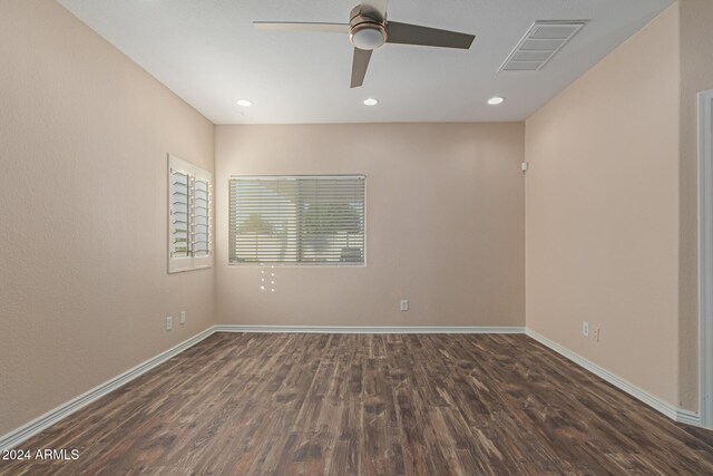 spare room with ceiling fan and dark hardwood / wood-style floors