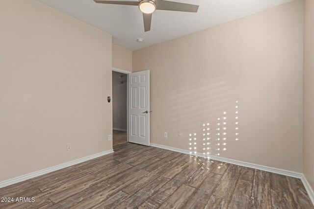 empty room with ceiling fan and wood-type flooring