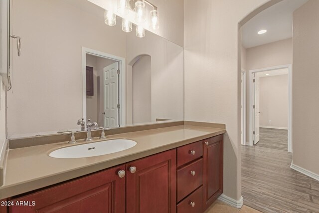 bathroom with vanity and wood-type flooring