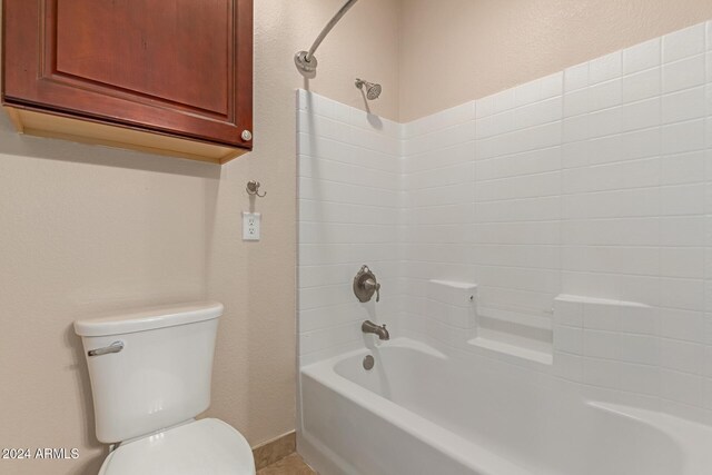 bathroom featuring toilet and washtub / shower combination