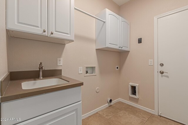 washroom featuring sink, washer hookup, cabinets, hookup for an electric dryer, and hookup for a gas dryer