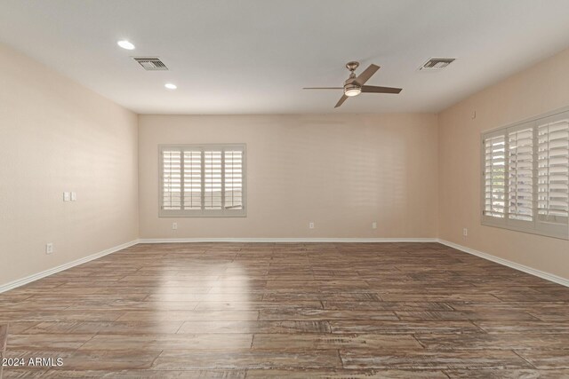 unfurnished room with hardwood / wood-style flooring and ceiling fan