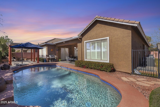 view of swimming pool featuring a fenced in pool, area for grilling, a patio, fence, and cooling unit