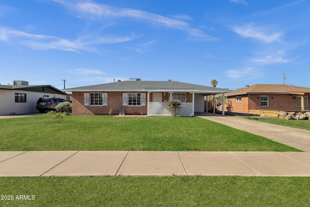 1944 W Osborn Rd, Phoenix, AZ 85015 - single story home with a carport, concrete driveway, a front yard, and brick siding